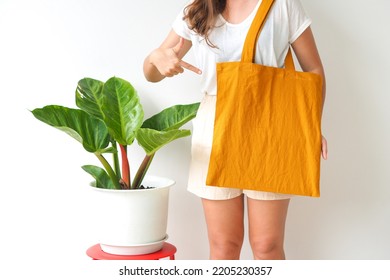 Woman Holding Canvas Tote Bag On White Background. Reusable Eco Bag For Shopping. Eco Friendly Concept. Mockup For Design.