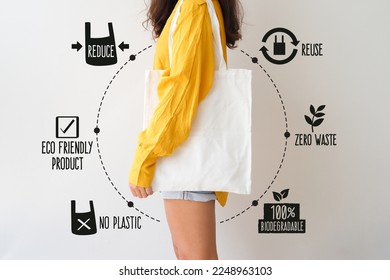 Woman holding canvas tote bag on white background. Reusable eco bag for shopping. Eco friendly concept.  - Shutterstock ID 2248963103