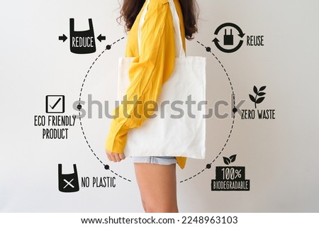 Woman holding canvas tote bag on white background. Reusable eco bag for shopping. Eco friendly concept. 