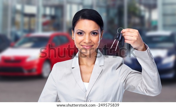 Woman holding a\
car key. Auto repair\
service