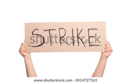 Woman holding cardboard banner with word Strike on white background, closeup