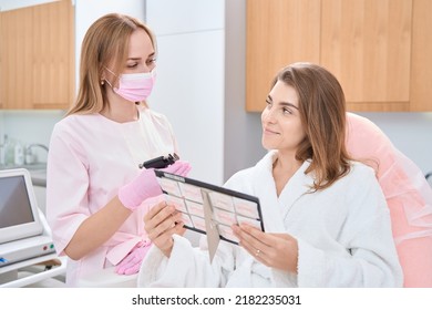 Woman Is Holding Catalog With Earring Near Professional Beautician