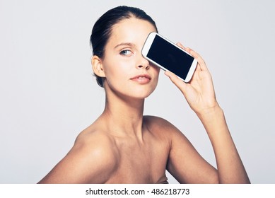 Woman Holding Cell Phone By Face