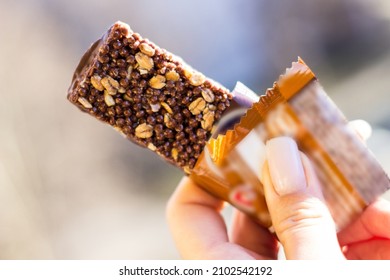 Woman Holding A Cereal Bar