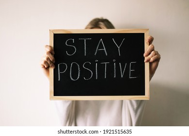 Woman Holding A Chalkboard With A Stay Positive Sign. 