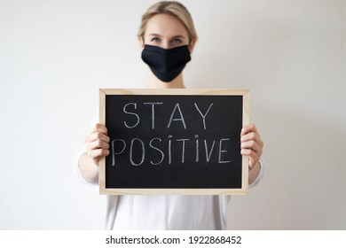 Woman Holding A Chalkboard With Stay Positive Sign. Motivation Concept. 