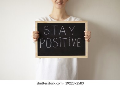 Woman Holding A Chalkboard With A Stay Positive Sign. Motivational Words.