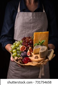 Woman Holding A Cheese Plate With Fruits And Jam