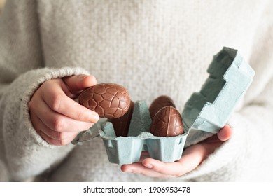 Woman Holding A Chocolate Egg From Egg Carton