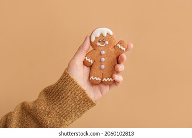 Woman holding Christmas cookie on color background - Powered by Shutterstock