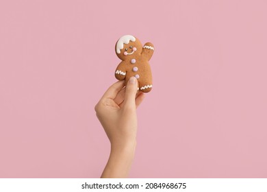 Woman holding Christmas cookie on color background - Powered by Shutterstock