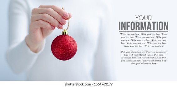 Woman Holding Christmas Toy Red Ball In Hand Decoration On Light Background