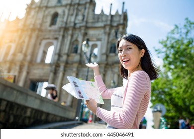 Woman holding city guide in Macao city