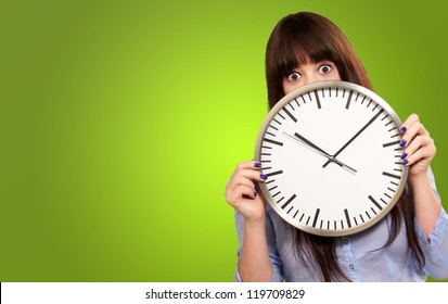 Woman Holding Clock Isolated On Green Background