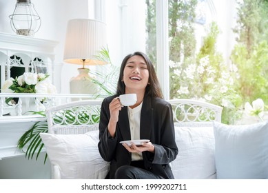 Woman holding coffee cup relaxing after work at office warm taste in cafe. Close up hands of woman sitting office desk holding sweet coffee cup relax and enjoy with happy time. Hot coffee mug in hand - Shutterstock ID 1999202711