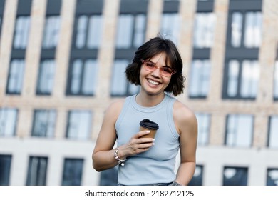 Woman Holding Coffee In Paper Cup