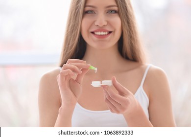 Woman Holding Contact Lens With Case On Light Background