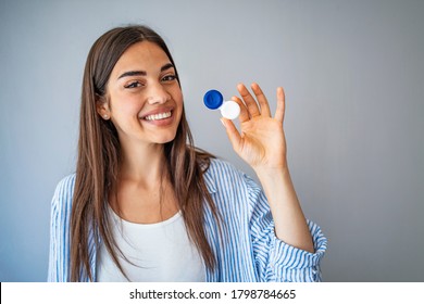 Woman  holding container for transparent soft contact lens. Young woman is preparing to insert lens in her eyes. Ophthalmic diseases and treatment. Poor vision concept.