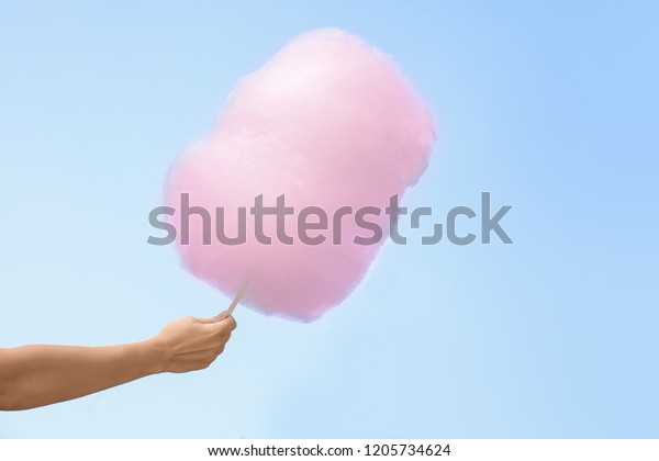 Woman Holding Cotton Candy Against Blue Stock Photo 1205734624 ...