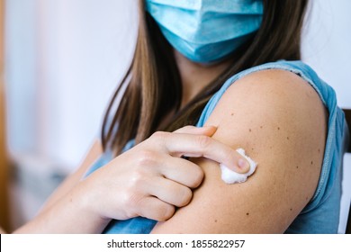 Woman Holding Cotton Wool On Her Arm After Covid 19 Injection