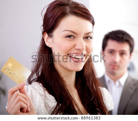 Woman holding a credit card happy with her financial solution