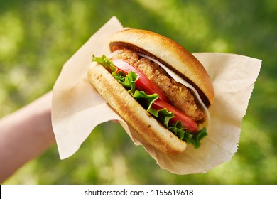 Woman Holding Crispy Chicken Sandwich From First Person View