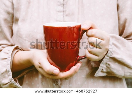Woman holding a cup