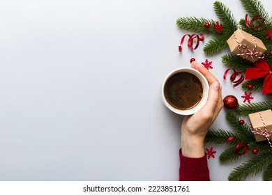 Woman holding cup of coffee. Woman hands holding a mug with hot coffee. Winter and Christmas time concept. - Shutterstock ID 2223851761