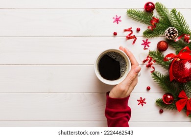 Woman holding cup of coffee. Woman hands holding a mug with hot coffee. Winter and Christmas time concept. - Shutterstock ID 2224462543