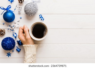 Woman holding cup of coffee. Woman hands holding a mug with hot coffee. Winter and Christmas time concept. - Shutterstock ID 2364739871
