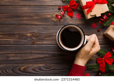 Woman holding cup of coffee. Woman hands holding a mug with hot coffee. Winter and Christmas time concept. - Powered by Shutterstock