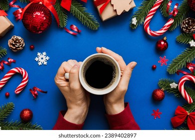Woman holding cup of coffee. Woman hands holding a mug with hot coffee. Winter and Christmas time concept. - Shutterstock ID 2389402897