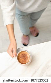 Woman Holding Cup Of Coffee At White Table, Top View