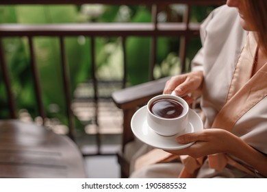 Woman Holding Cup Of Hot Steaming Drink Tea On The  Balcony With Tropical View