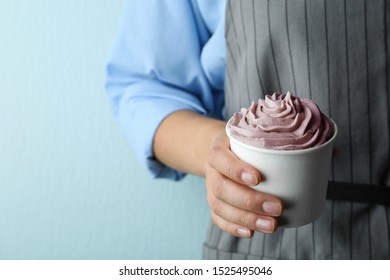 Woman Holding Cup With Tasty Frozen Yogurt On Blue Background, Closeup