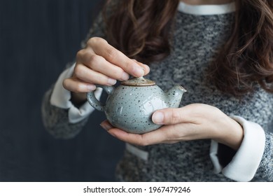 Woman Holding A Cup Of Tea In Her Hands.