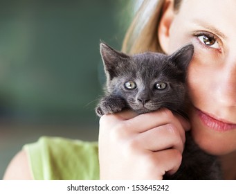 Woman Holding Cute Black Kitten