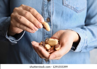 Woman Holding Delicious Brazil Nuts, Closeup View