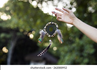 Woman Holding Dream Catcher In Nature