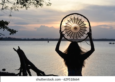 Woman Holding Dream Catcher On The Beach