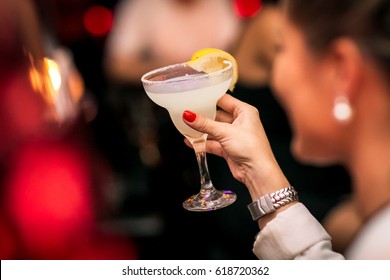 A woman holding a drink