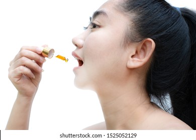 Woman Holding A Dropper Sublingual Cannabis Oil At White Background