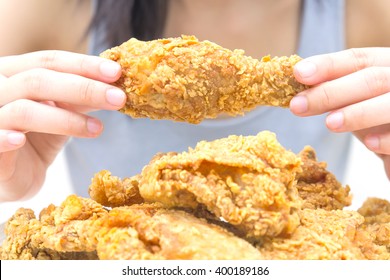 Woman Holding And Eatting Fried Chicken In White Plate On White Table