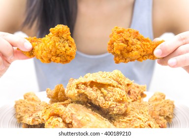 Woman Holding And Eatting Fried Chicken In White Plate On White Table