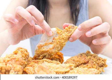 Woman Holding And Eatting Fried Chicken In White Plate On White Table