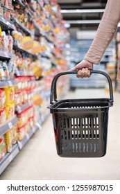 A Woman Is Holding The Empty Basket In Super Market