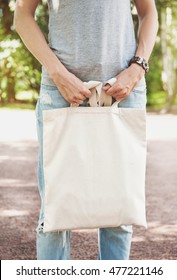 Woman Holding Empty Canvas Bag Outdoor. Template Mock Up