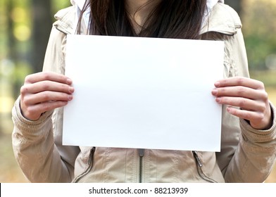Woman holding empty paper in hands