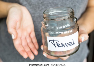 A Woman Is Holding An Empty Piggy Bank For Travel. No Money Concept