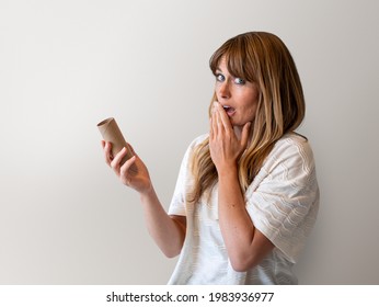 Woman holding an empty toilet paper roll during coronavirus pandemic mockup